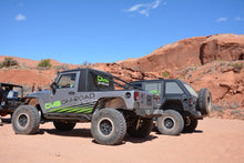 Load image into Gallery viewer, DV8 Offroad 07-18 Jeep Wrangler JK Steel Rock Guard/Sliders - Black (4 Door)